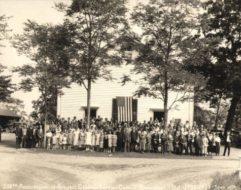 Group of people standing in front of a church, sepia image