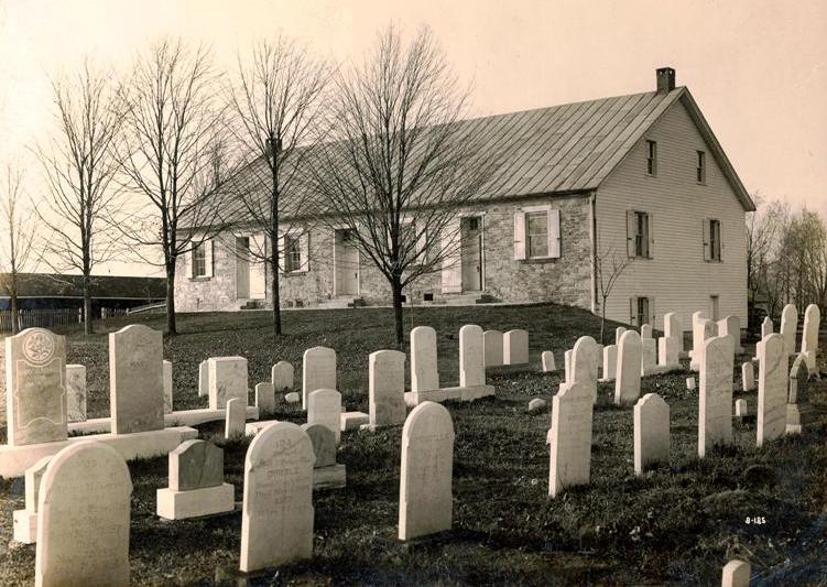 Cemetery in the foreground, church in the background, separated by trees